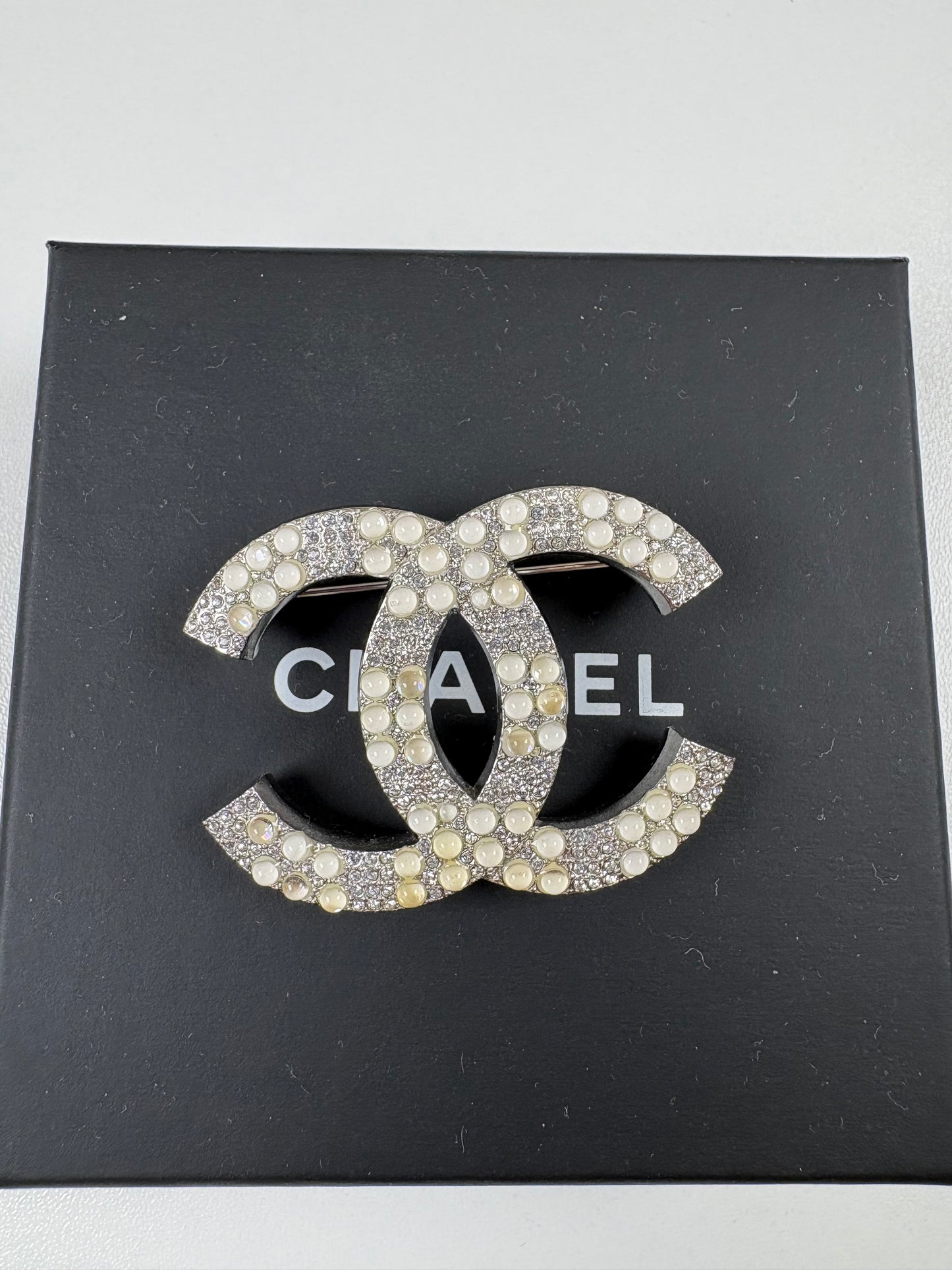 Pre-Owned CHANEL™ Silver Tone Interlocking CC Logo Brooch, Silver