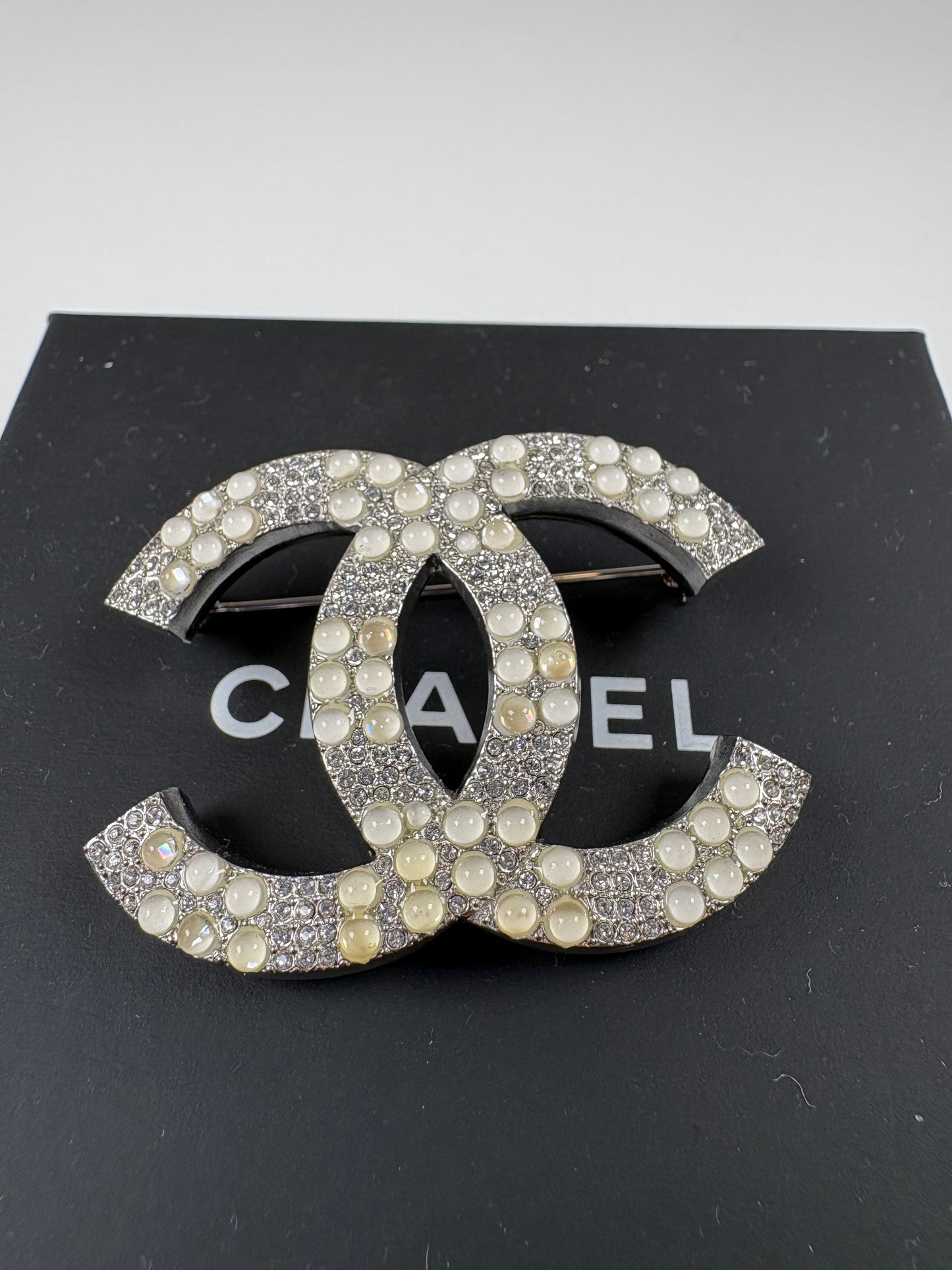 Pre-Owned CHANEL™ Silver Tone Interlocking CC Logo Brooch, Silver