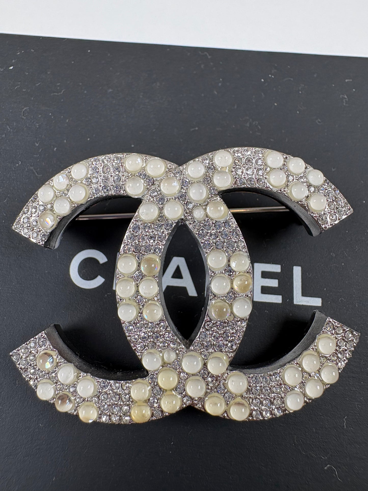 Pre-Owned CHANEL™ Silver Tone Interlocking CC Logo Brooch, Silver